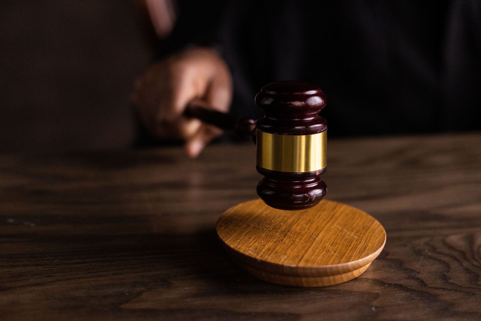 A gavel resting on a wooden sound block